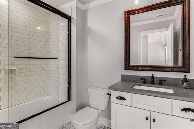 full bathroom featuring vanity, ornamental molding, toilet, and combined bath / shower with glass door