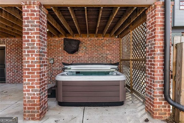 view of patio / terrace with a hot tub