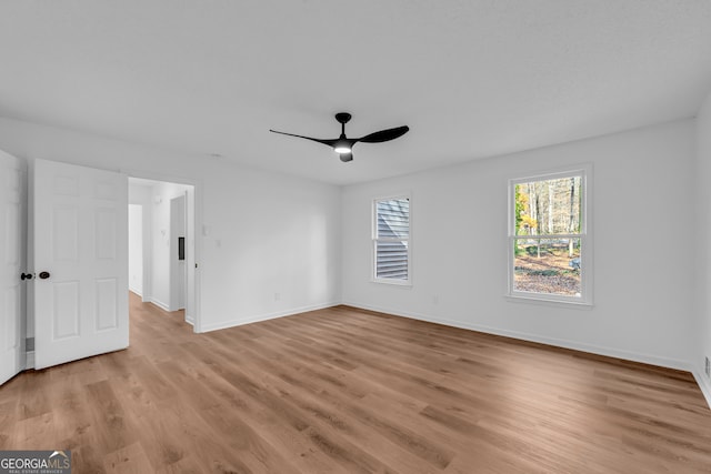 empty room featuring light hardwood / wood-style flooring and ceiling fan