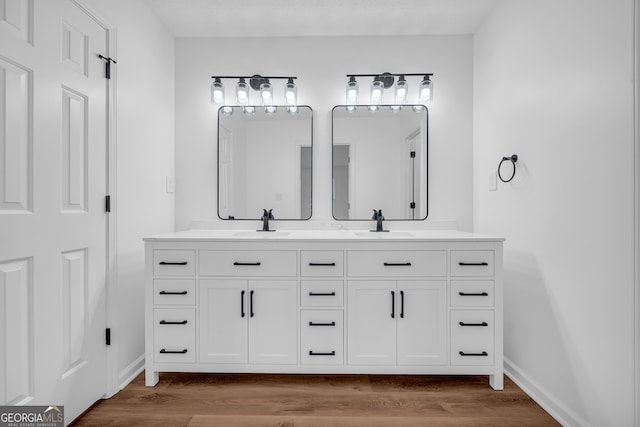 bathroom featuring hardwood / wood-style flooring and vanity