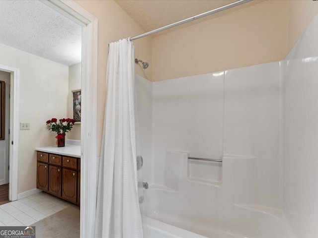 bathroom with tile patterned flooring, a textured ceiling, and shower / tub combo with curtain