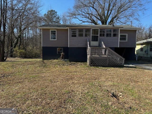 view of front facade with a sunroom and a front yard