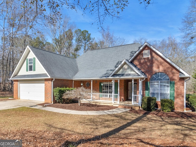 view of front of home with a garage, a front yard, and covered porch