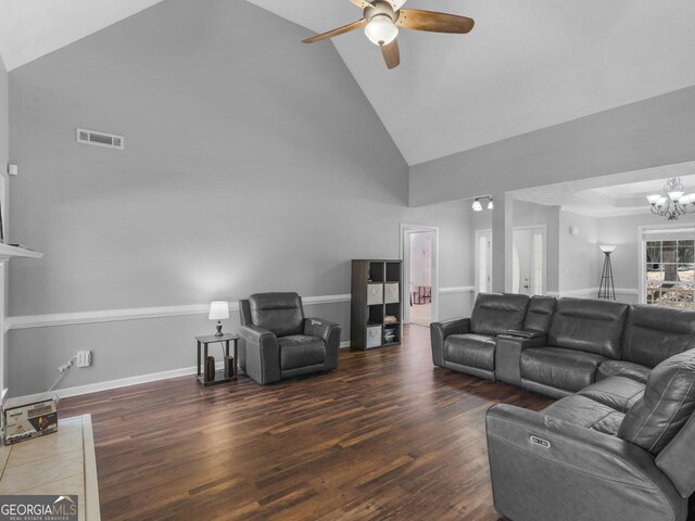 living room featuring ceiling fan with notable chandelier, high vaulted ceiling, and dark hardwood / wood-style floors