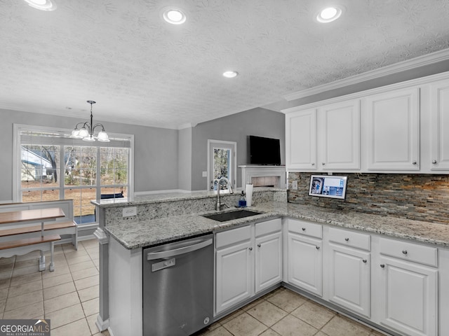 kitchen featuring sink, dishwasher, white cabinetry, a textured ceiling, and kitchen peninsula