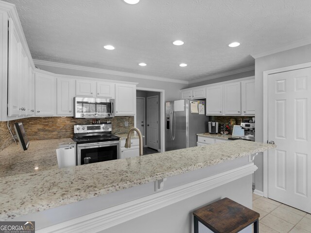 kitchen featuring white cabinetry, light tile patterned floors, stainless steel appliances, and kitchen peninsula