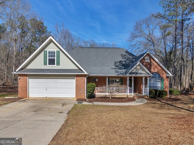 view of front of property with a porch and a garage