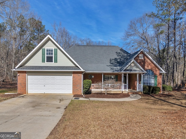 view of front facade with a garage, covered porch, and a front yard