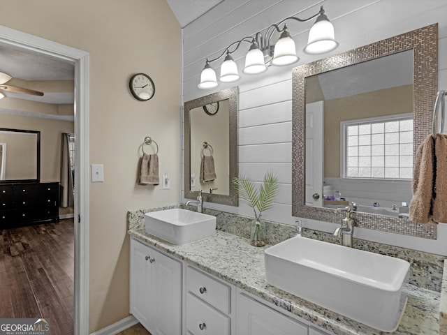 bathroom with vanity, a bathing tub, wood-type flooring, and ceiling fan