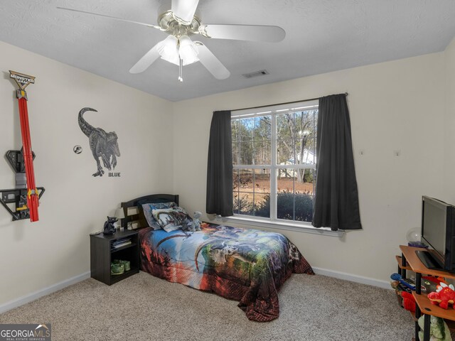 bedroom with ceiling fan and light carpet