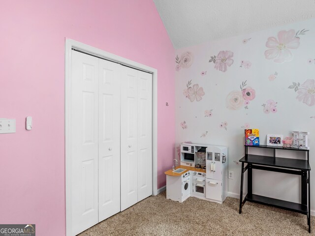 recreation room with lofted ceiling and light colored carpet