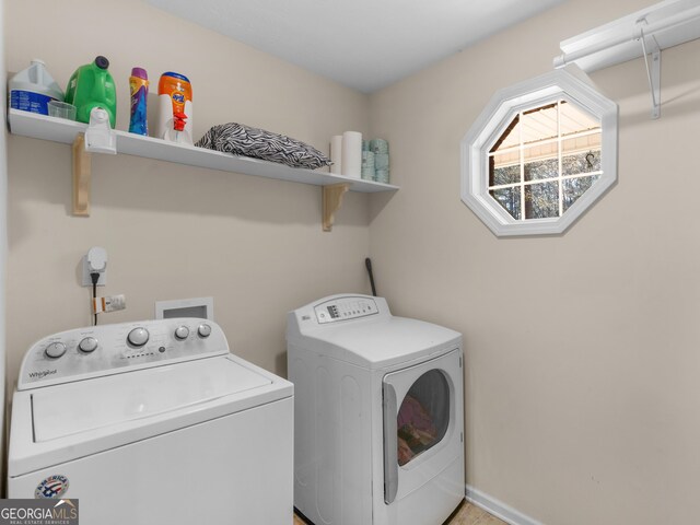 clothes washing area with washer and clothes dryer