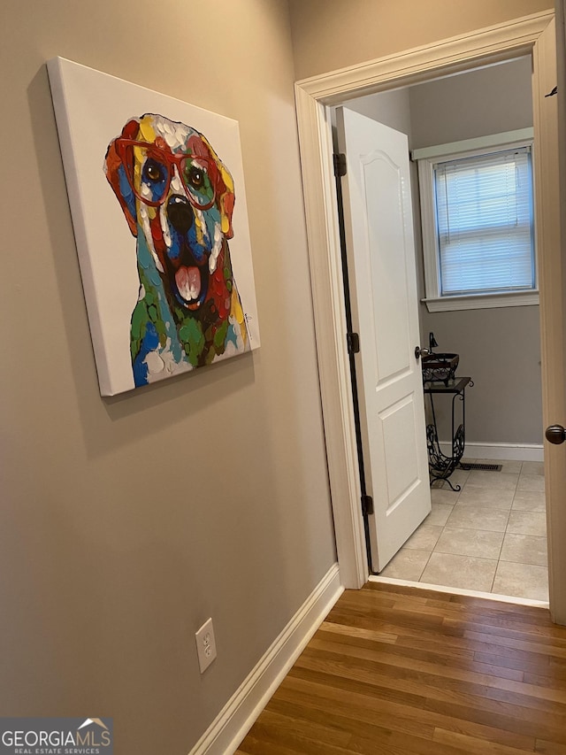 hallway with light hardwood / wood-style floors