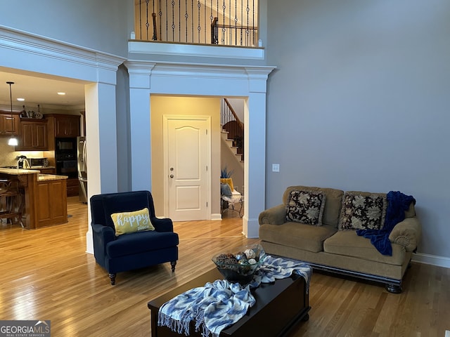 living room with sink and light wood-type flooring