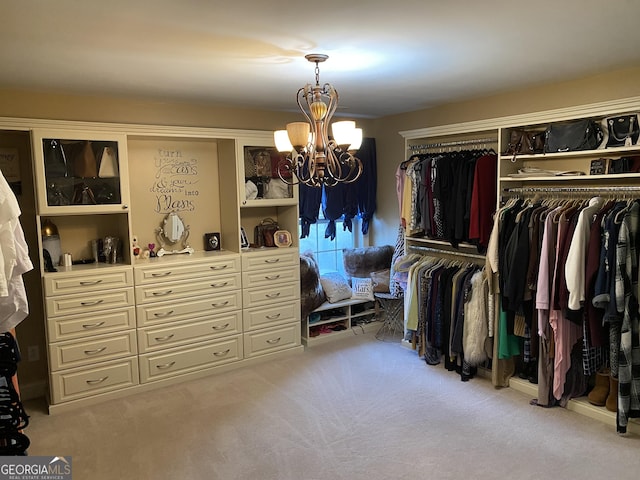 walk in closet featuring light carpet and a notable chandelier