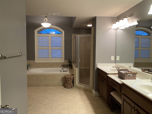 bathroom featuring vanity, tile patterned floors, and plus walk in shower