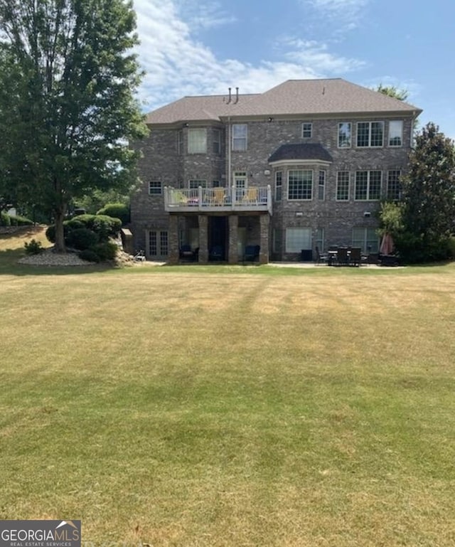 rear view of house with a yard