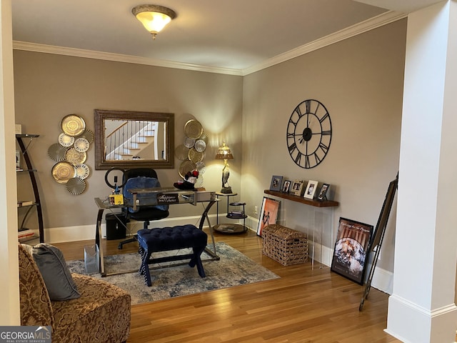 living area with ornamental molding and light wood-type flooring