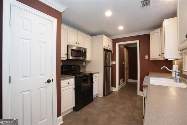 kitchen with white cabinetry, sink, crown molding, and appliances with stainless steel finishes