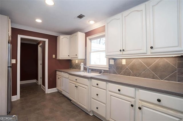 kitchen with tasteful backsplash, white cabinetry, sink, stainless steel fridge, and white dishwasher