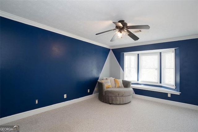 sitting room with ceiling fan, ornamental molding, and carpet floors