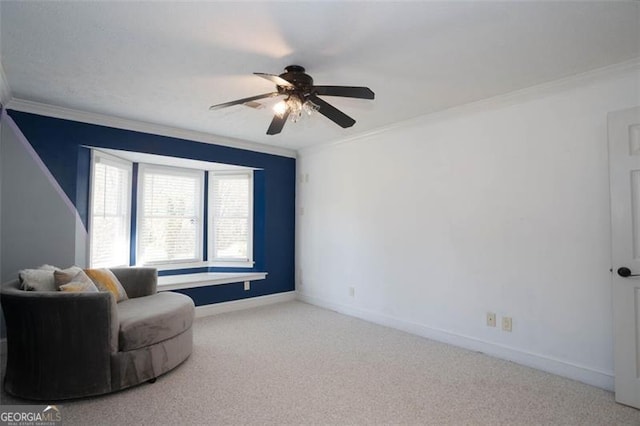 living area featuring crown molding, carpet floors, and ceiling fan