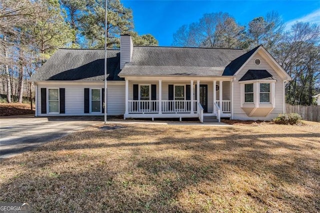 ranch-style home featuring a front yard and a porch