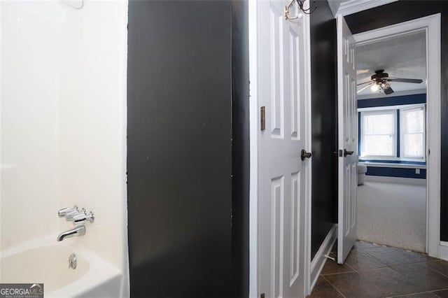 bathroom with tile patterned floors and shower / bath combination