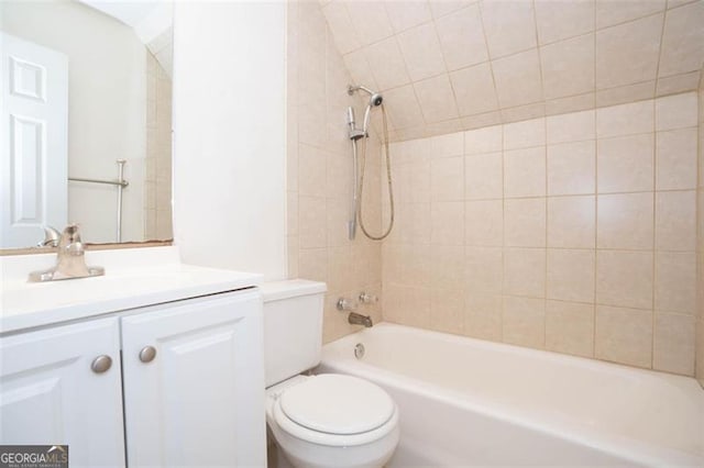 full bathroom featuring vanity, toilet, and tiled shower / bath combo