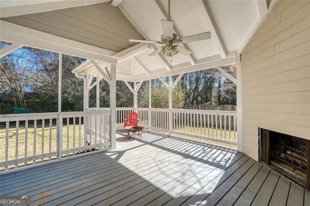 wooden deck featuring ceiling fan