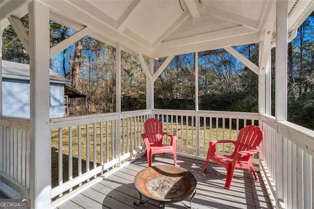 sunroom / solarium featuring lofted ceiling