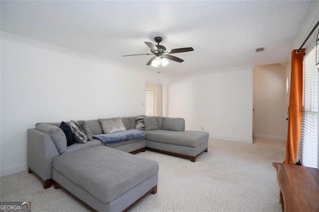 carpeted living room with crown molding and ceiling fan