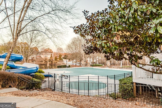 view of swimming pool with a water slide