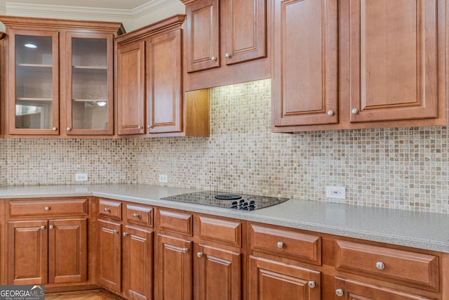 kitchen with tasteful backsplash, crown molding, and black electric cooktop