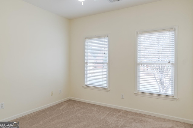 carpeted empty room with a healthy amount of sunlight