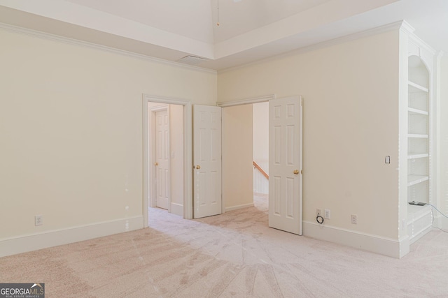 unfurnished bedroom featuring crown molding and light carpet