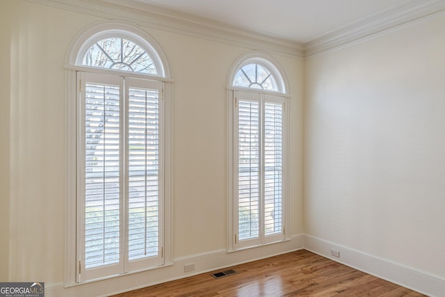 interior space with crown molding and wood-type flooring