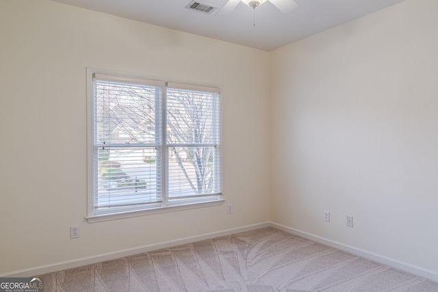 spare room with carpet floors and ceiling fan