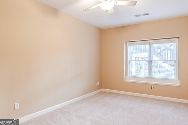 unfurnished room featuring light carpet and ceiling fan