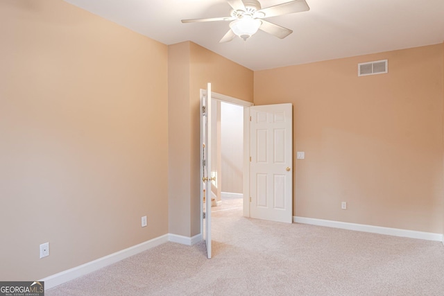 unfurnished bedroom featuring light colored carpet and ceiling fan