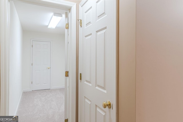 hallway featuring light carpet