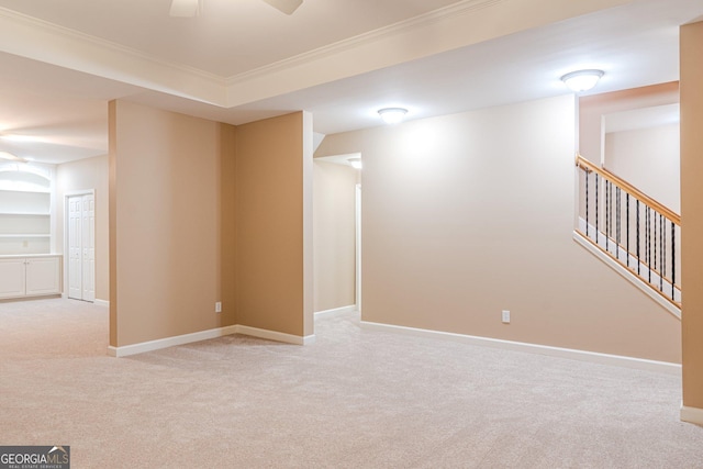 interior space featuring ceiling fan, light colored carpet, ornamental molding, and built in features