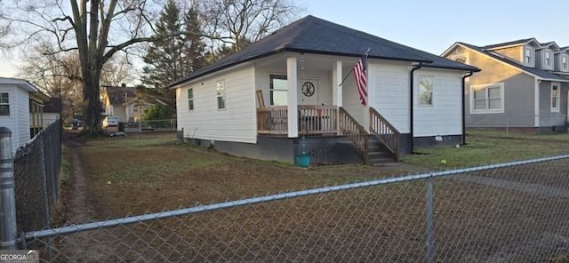 bungalow-style house featuring a front lawn and fence private yard