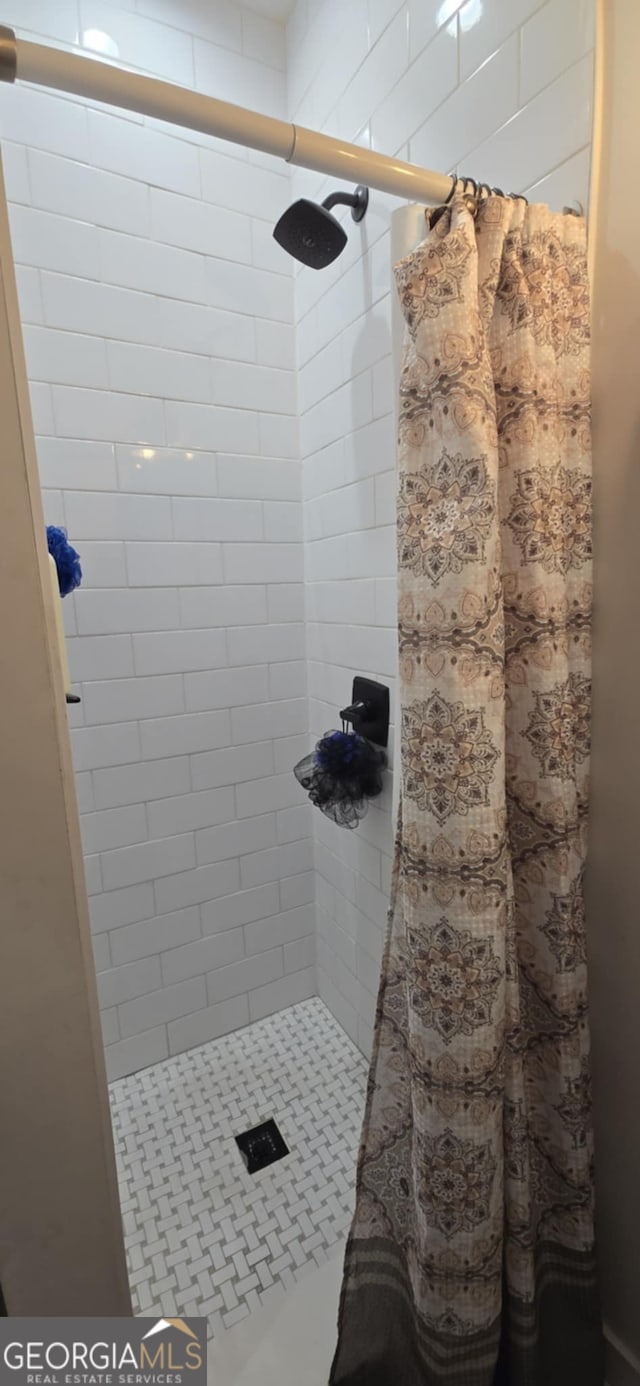 full bath featuring a shower stall