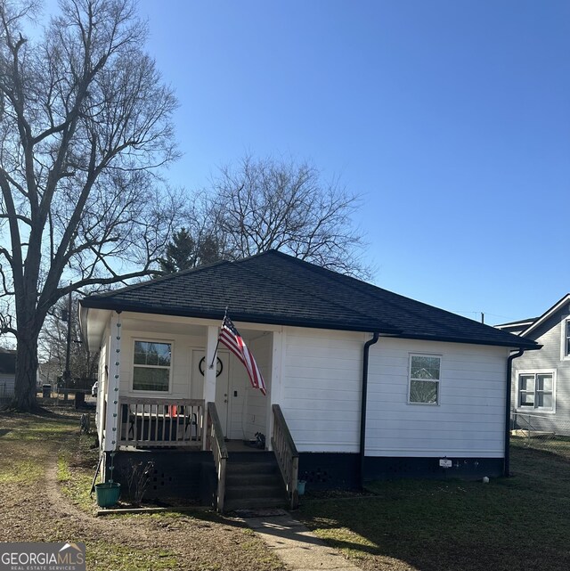 exterior space with an outdoor structure, a yard, central AC, and a trampoline