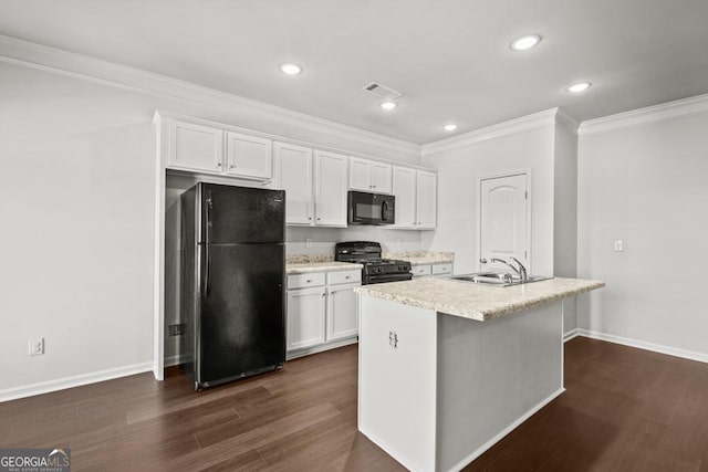 kitchen featuring white cabinets, sink, an island with sink, and black appliances