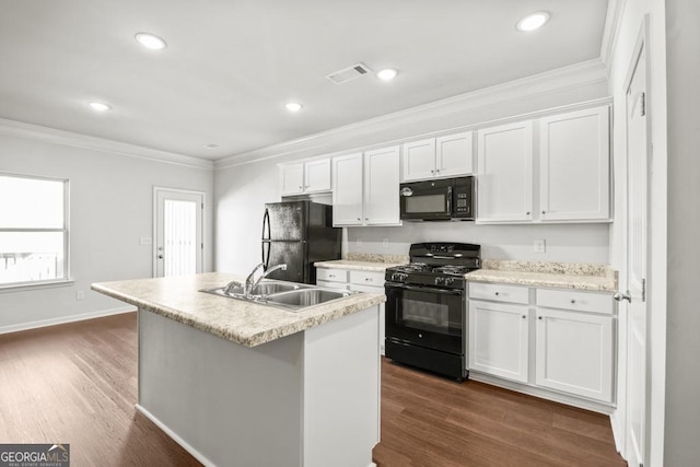 kitchen featuring sink, crown molding, black appliances, a center island with sink, and white cabinets