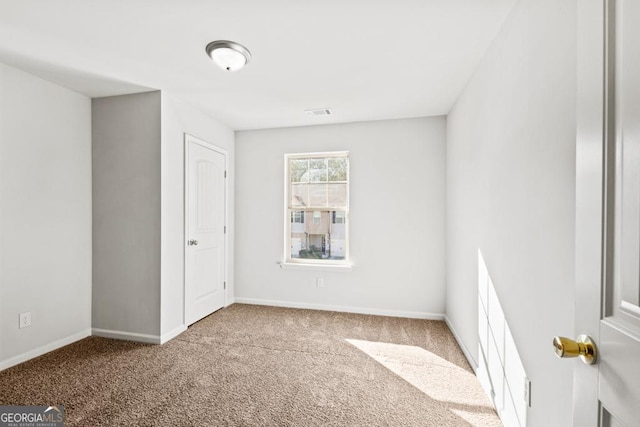 unfurnished room with carpet flooring