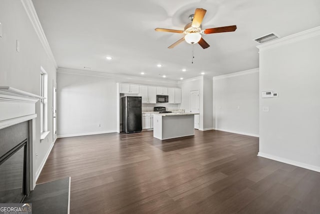 unfurnished living room with dark wood-type flooring, ceiling fan, and ornamental molding