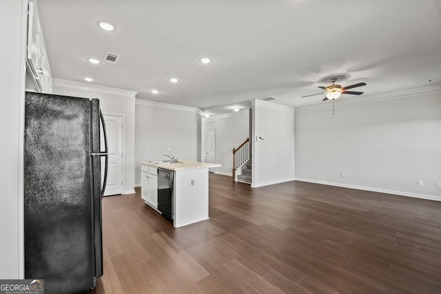 kitchen with white cabinetry, sink, a kitchen island with sink, and black appliances